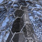 The intricate lattice structure of the Rokko-Shidare Observatory at Rokko Garden Terrace in Kobe, captured against a clear blue sky, symbolizing the architecture of silence.