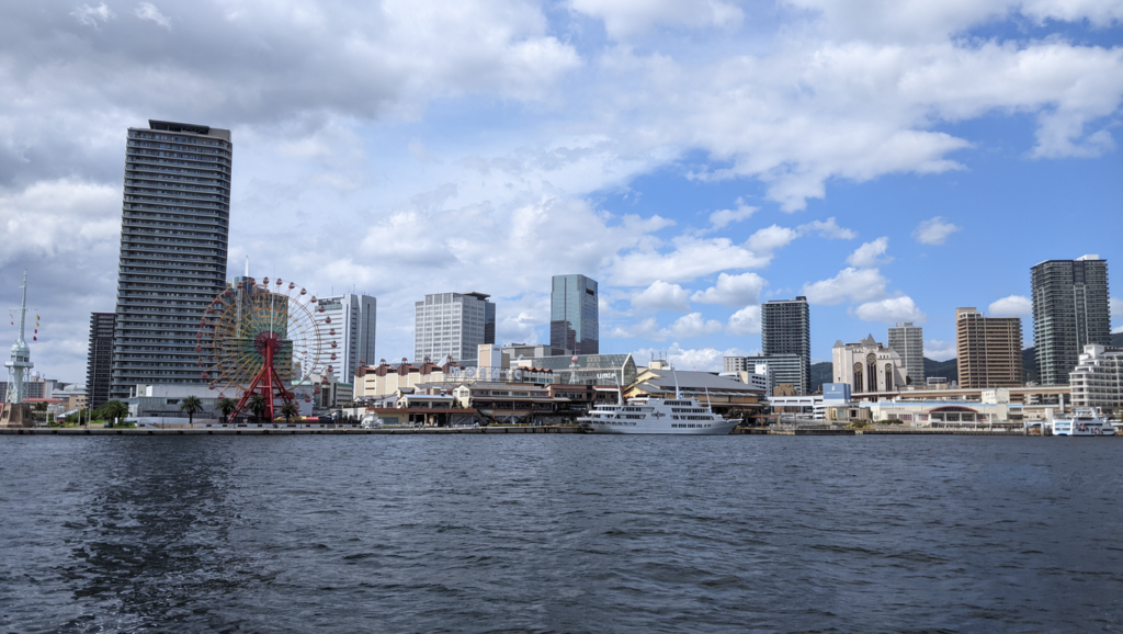 A panoramic view of Kobe Harborland across the harbor from Meriken Park featuring MOSAIC and umie